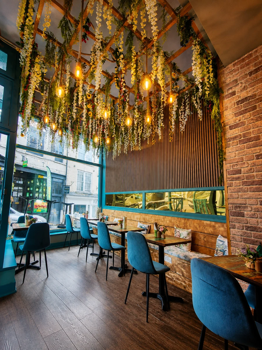 The colourful interior of 26 Elvet with exposed brick and hanging flowers